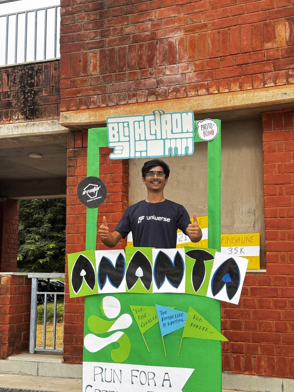 A Runiverse team member smiling in the Ananta Run photo booth at IIT Gandhinagar.